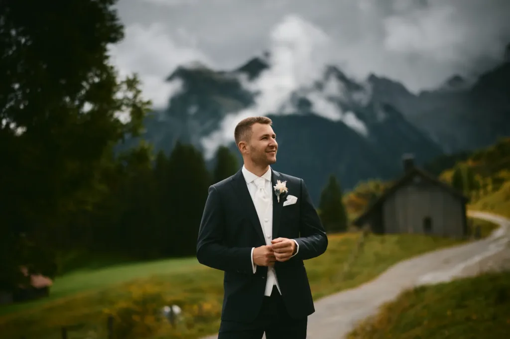 Bräutigam Portraet vor alpiner Kulisse